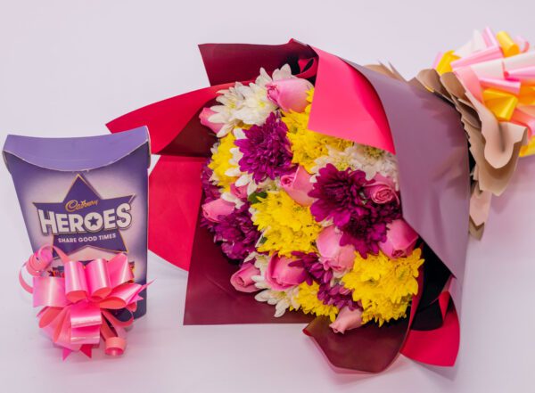 Pink Rose Flowers, Mixed Chrysanthemums and Cadbury Heroes Chocolates
